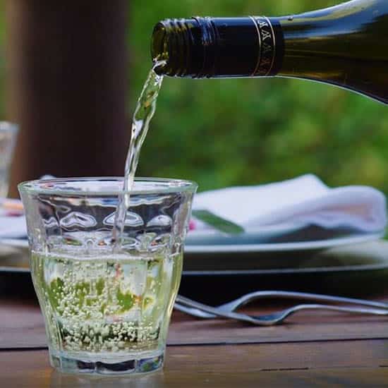 Learn how you can still be a part of Virtual Vail with white wine pouring into a glass.