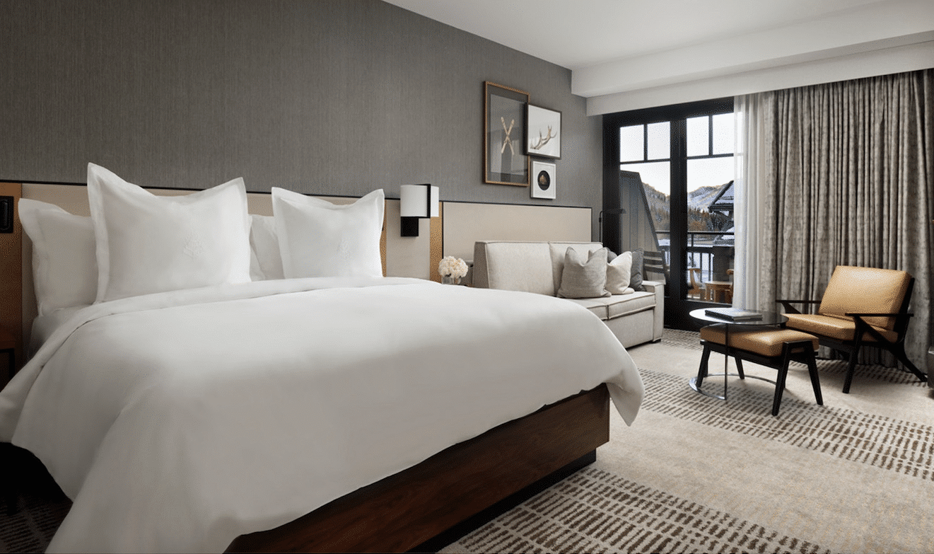 A bed in a hotel room with a view.