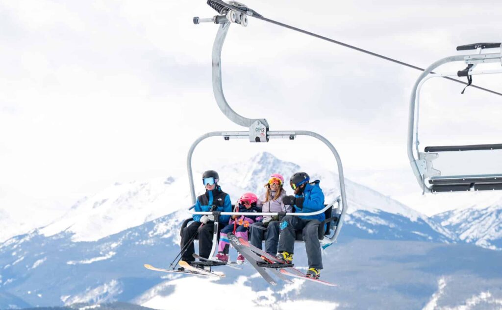 family on a chairlift in the mountains