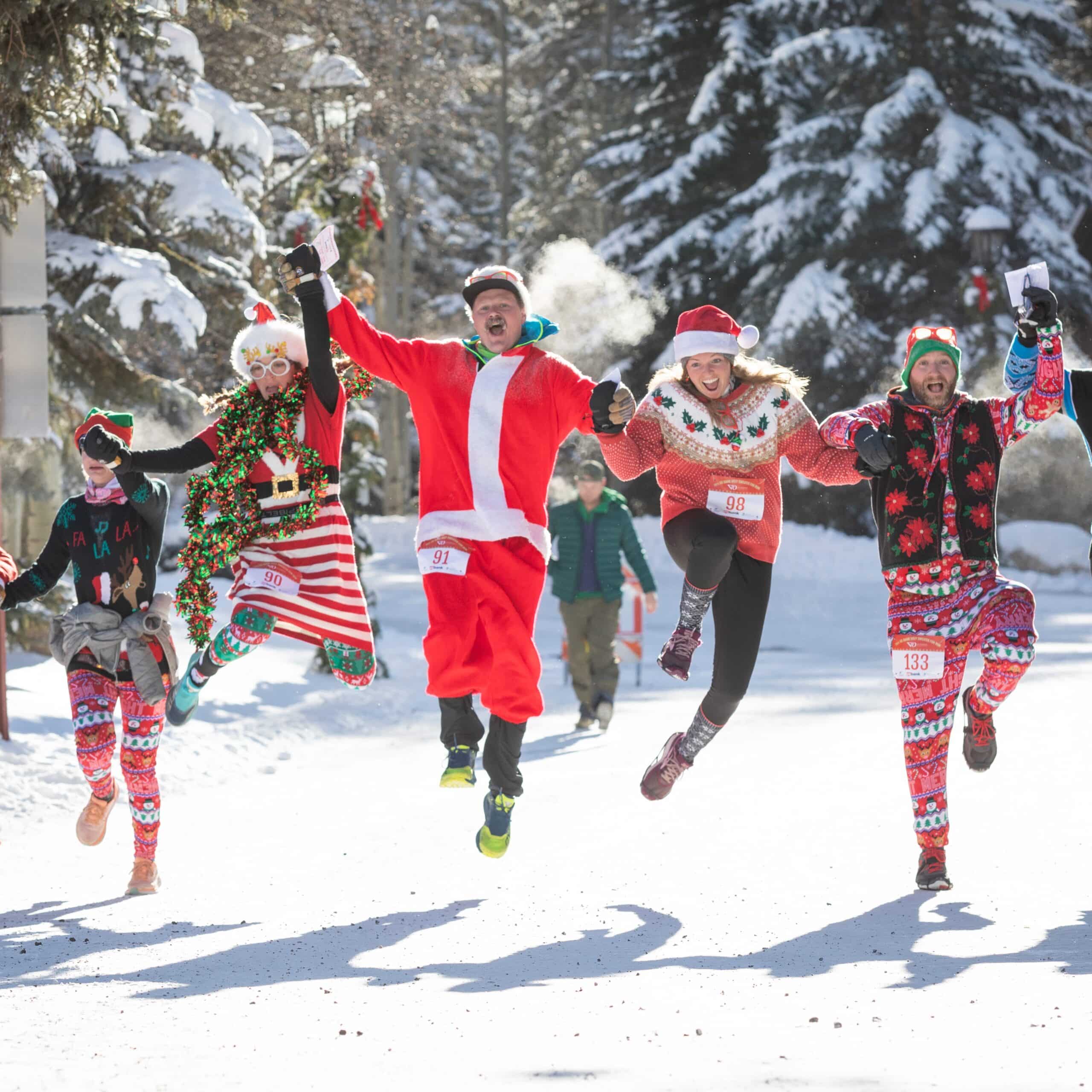 A group of people jumping in the snow.