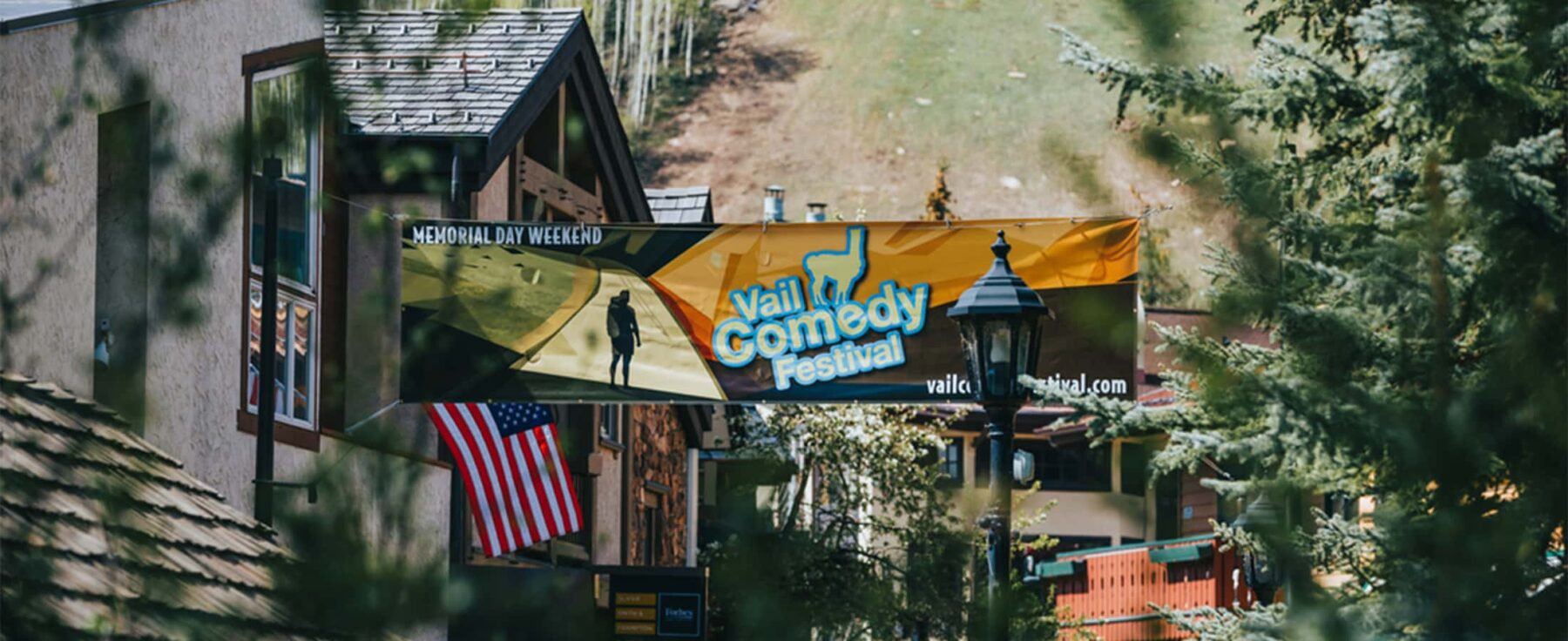 A banner hung above the streets of Vail, Colorado, announces the Memorial Day weekend event, Vail Comedy Festival.