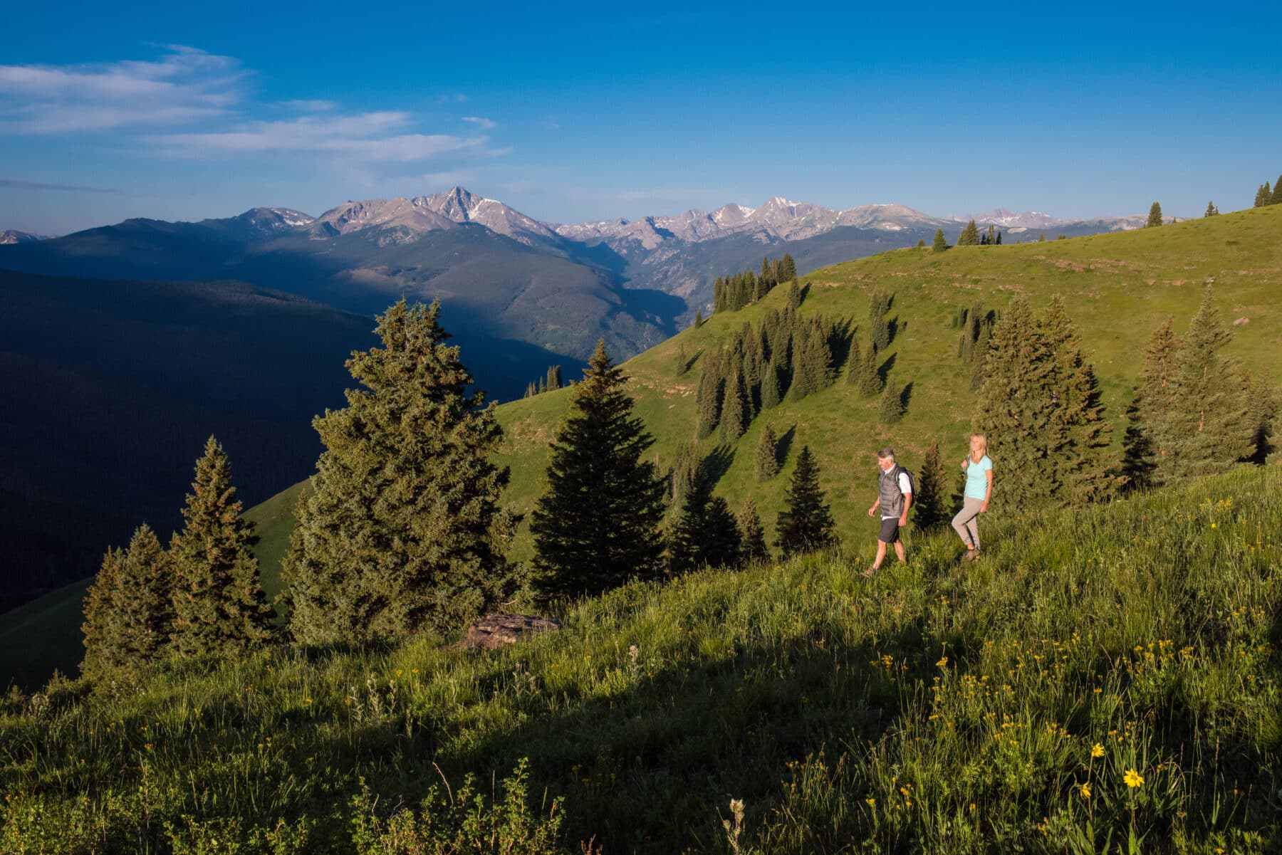 Couple on trail with Gore Range