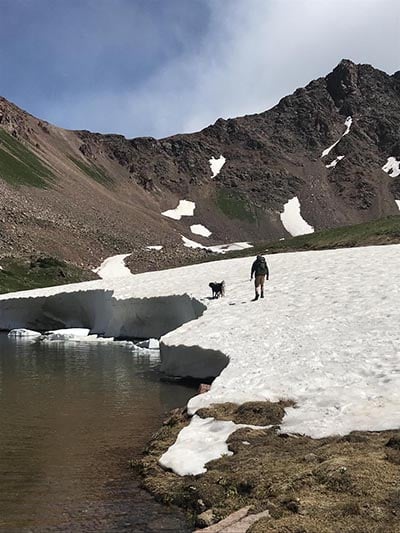 deluge alpine lake melt with person and dog