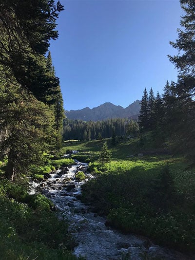 creek along trail with mountains in distance