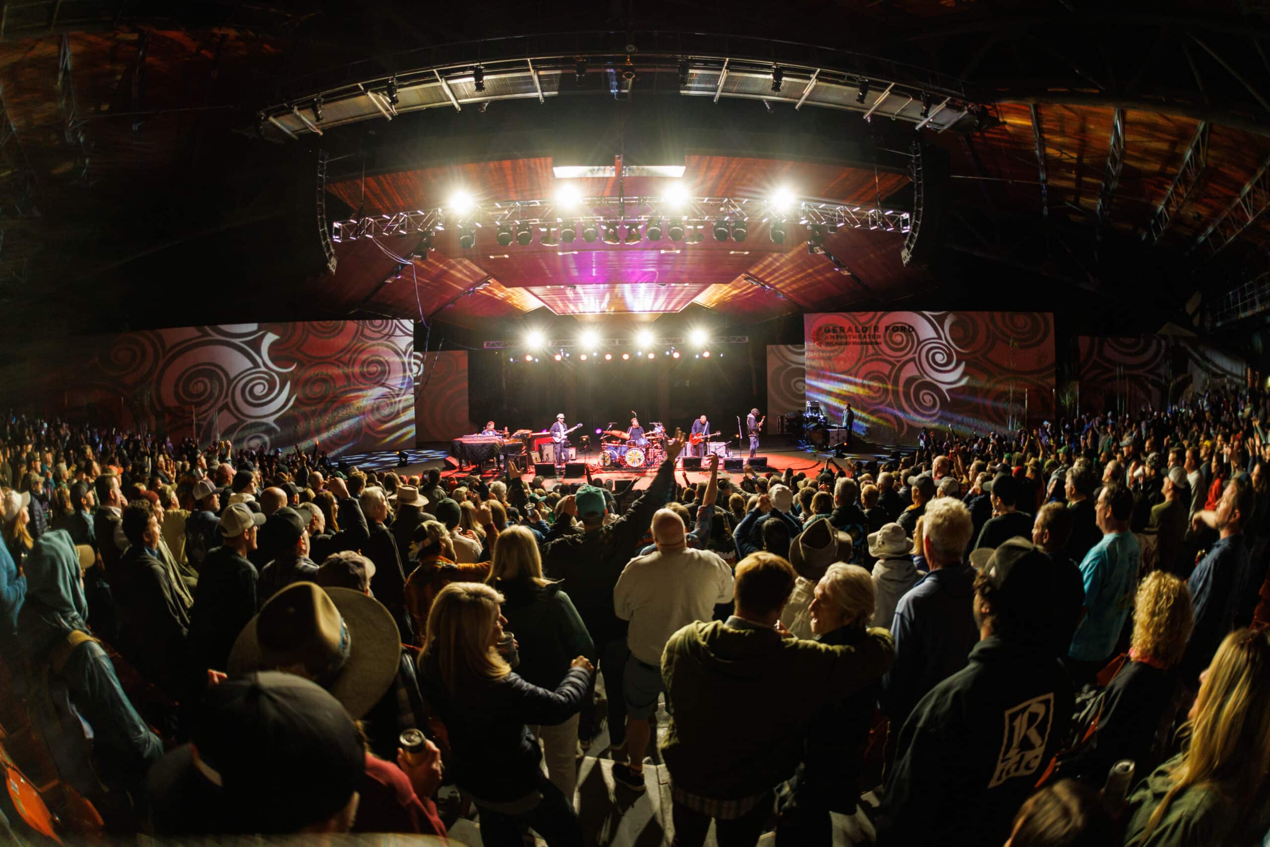 Gerald R. Ford Amp with bright lights on the stage and people dancing