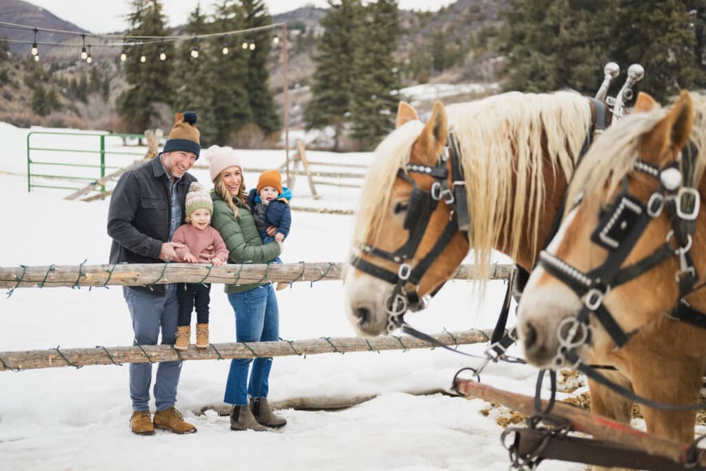 a family with horses in the winter