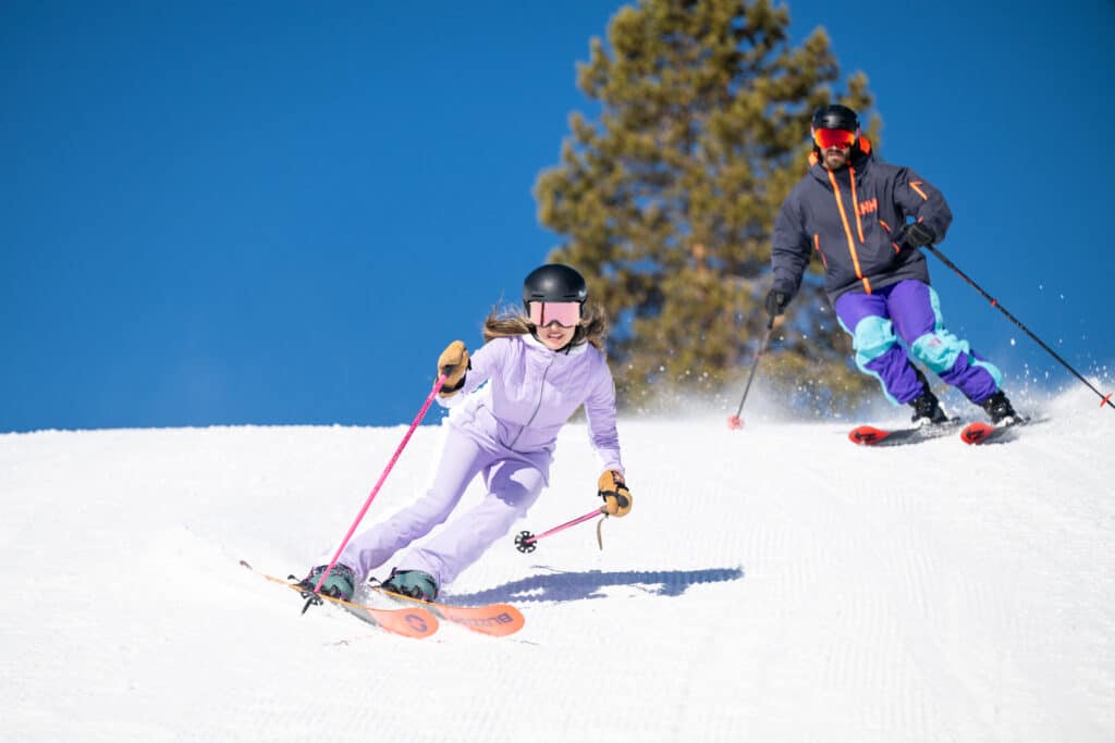 a couple skiing down vail mountain
